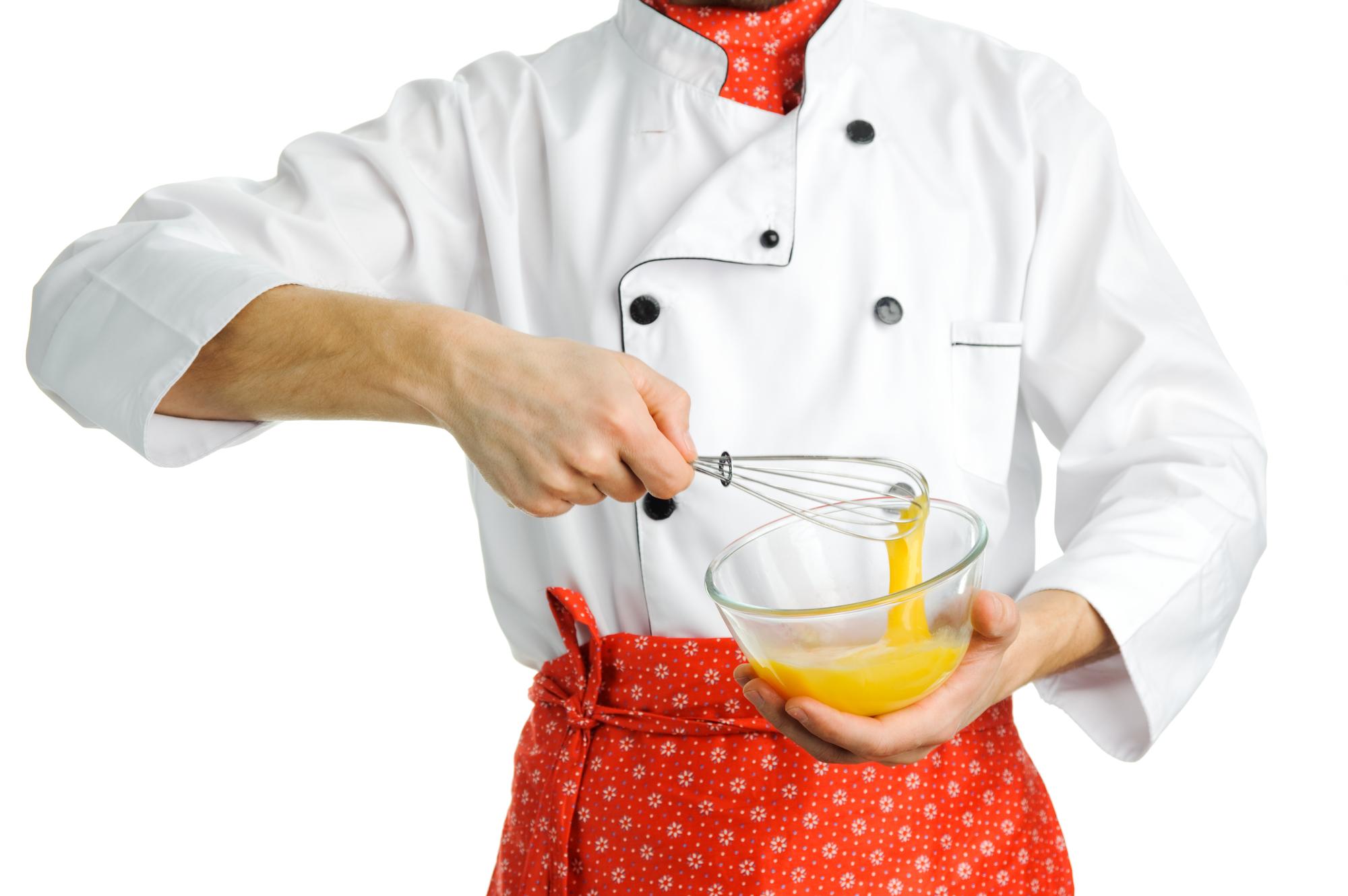 Chef demonstrating sauce technique to small group